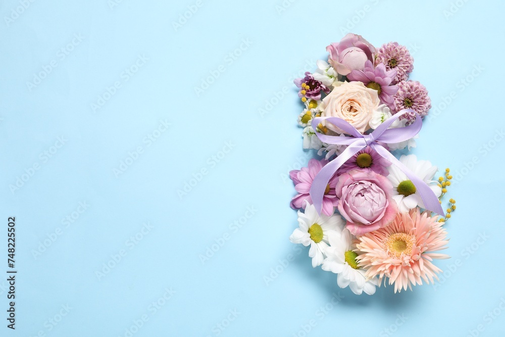 8 March greeting card design made with beautiful flowers on light blue background, top view. Space for text