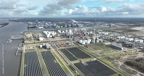 Heavy industrial zone at Moerdijk, including the petrochemical refinery along the Hollands Diep canal river, solar panels, and shipping transport routes. Aerial birds eye drone view. photo