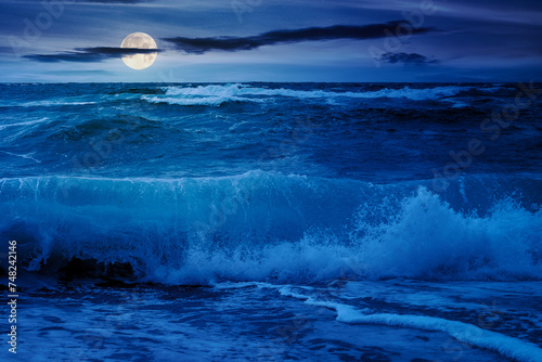 Obraz na płótnie dramatic seascape at night. waves crashing on the beach in full moon light w salonie