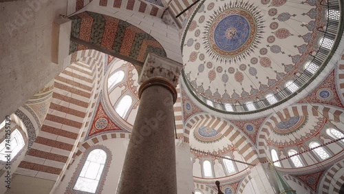 View of the dome cover of the Valide-i Atik Mosque in Istanbul. The camera rotates around the support column. photo