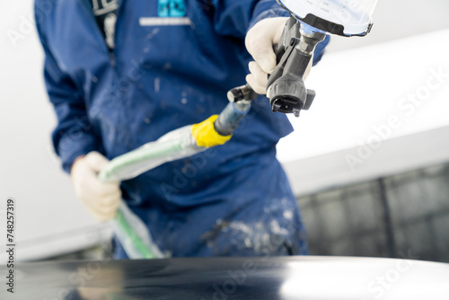 person spraying car paint  photo