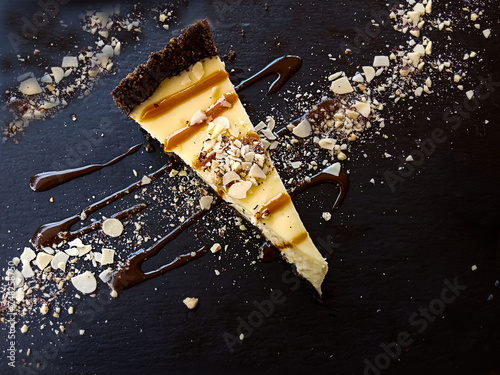 Appetizing piece of dessert on dark dishes, top view