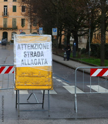 Large warning sign with big text in italian language that means CAUTION FLOODED ROAD photo