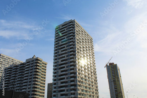 building under construction with crane and skyscrapers on background