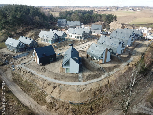 Construction of a modern housing estate in the style of a modern barn