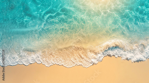 An aerial view captures the gentle embrace between the azure waves and the soft sandy beach, creating a tranquil and picturesque scene