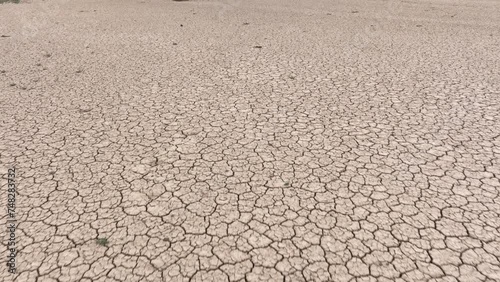 Aerial shot looking down at the cracked surface of a dry lake in Navada