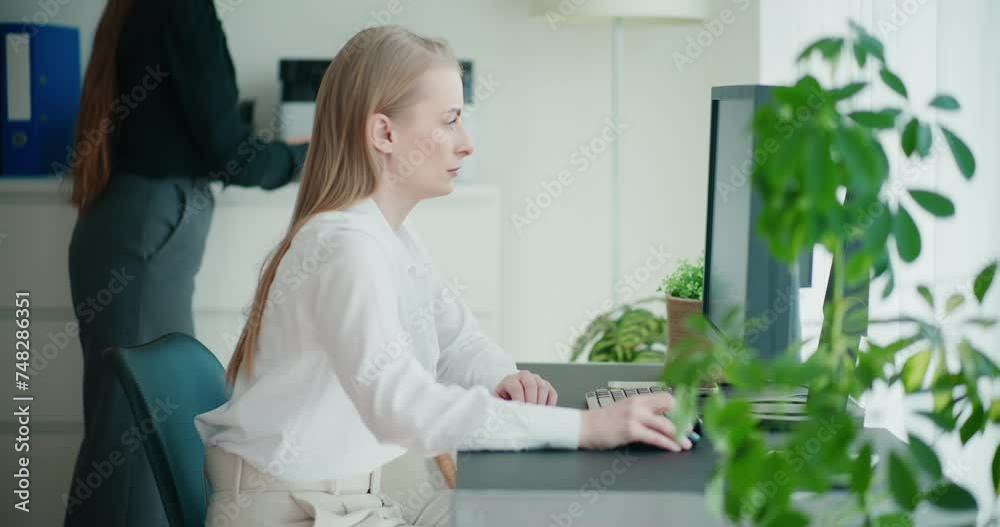 Confident young businesswoman using computer Confident young businesswoman using computer