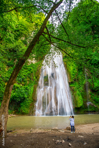 Visitor Capturing the Majestic Lowe Waterfall, Loveh, Golestan Province, Iran photo