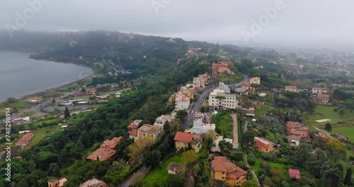 Aerial view of Castel Gandolfo Lake Albano in Italy. Mountain slopes and houses on the shore of the lake cliff. High quality 4k footage