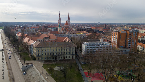 Drone footage from downtown of Szeged, Hungary on a sunny winter day. Szeged, Drone, Aerial, Hungary, Urban Landscape, Szeged Cathedral, Tisza River, Bridge