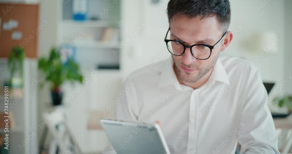 Confident businessman browsing internet on digital tablet