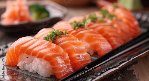 a plate of sushi has salmon and chopsticks