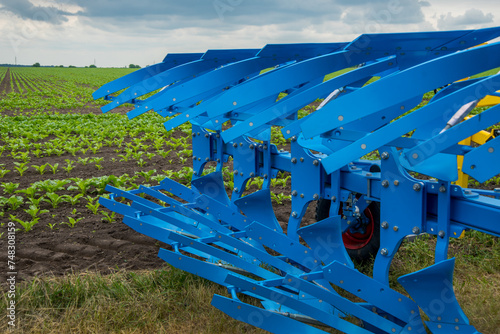 Agricultural plow for deep plowing on a tractor trailer. A close-up of a blue...