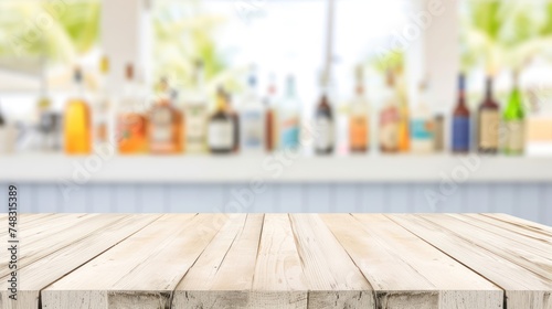 a wooden table top in front of a window with bottles of alcohol in the backgroung of the room. photo