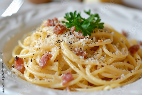 A plate of spaghetti alla carbonara, a classic Roman pasta dish made with eggs, Pecorino cheese, guanciale (a type of Italian cured meat made from pork cheeks), and black pepper.