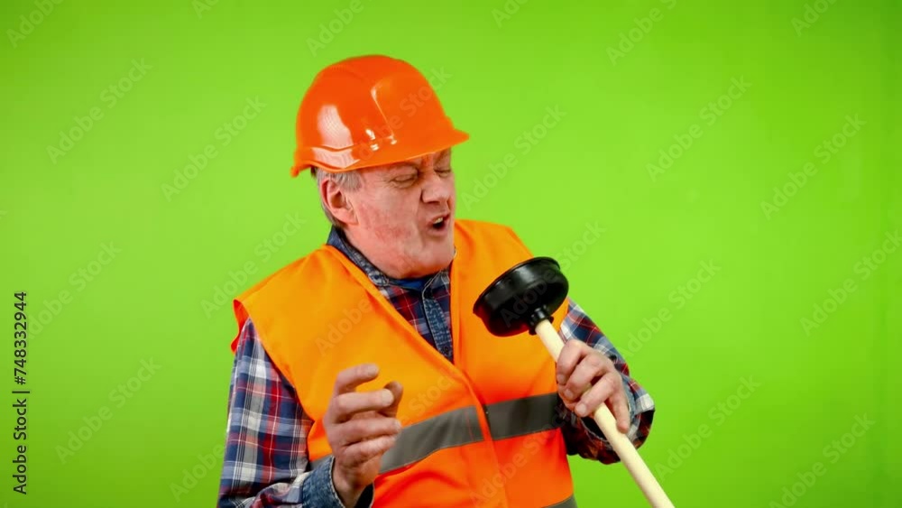 Funny plumber imitating singing with plunger. Funny plumber imitating singing with plunger.