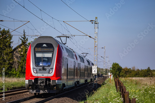 A regional train on a railroad line in the sunshine