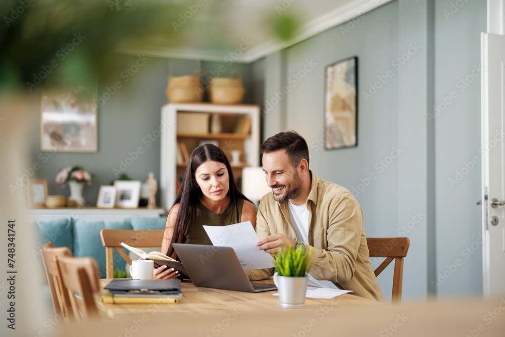 Couple at home office with laptop Couple at home office with laptop