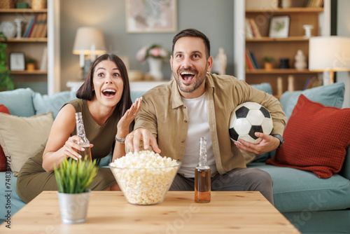 Couple cheers for soccer match from home