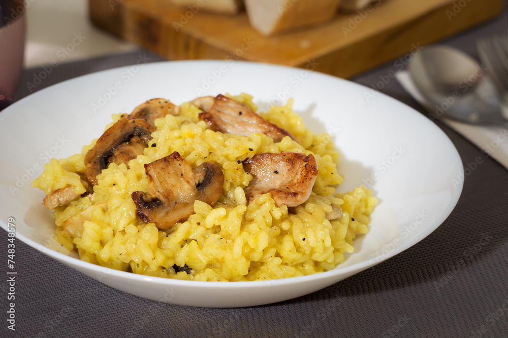 Rice dish with mushrooms and pork, spiced with saffron.