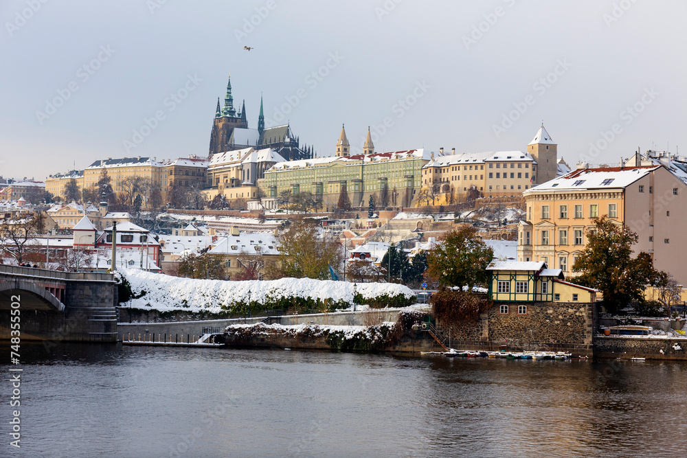 Snowy Prague City with gothic Castle in the sunny Day, Czech Republic