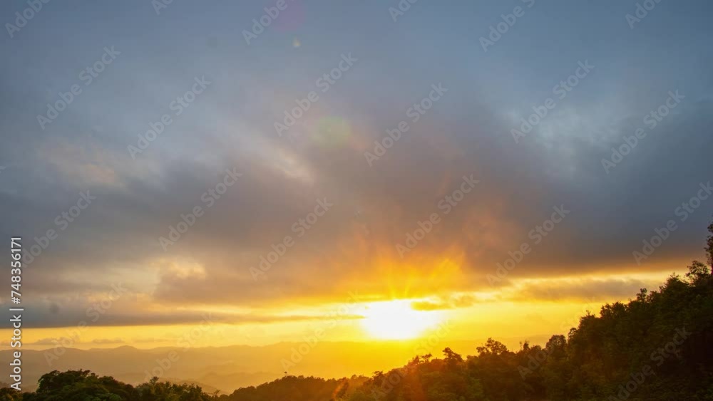 time lapse day to night wonderful The rays of the sun shine through the clouds above .the high peak of Phu Ta Jor in Phang Nga..The rays of the sun shine through the clouds at beautiful sunset.. time lapse day to night wonderful The rays of the sun shine through the clouds above .the high peak of Phu Ta Jor in Phang Nga..The rays of the sun shine through the clouds at beautiful sunset..