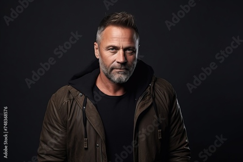 Portrait of a stylish mature man in a leather jacket. Men's beauty, fashion.