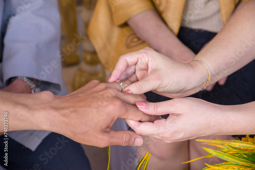 Couple  holding hands and ring for marriage  commitment or wedding in ceremony  love or support. Closeup of people getting married  vows or accessory for symbol of bond  relationship or partnership .