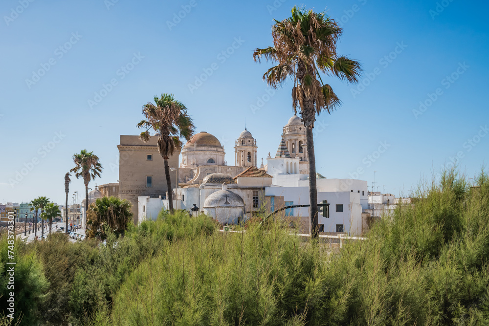 Famous cathedral of Santa Cruz de Cádiz in baroque style and sea front promenade del Vendaval, SPAIN