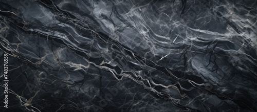 A high-resolution black and white marble texture background, showcasing a natural pattern of swirling veins and intricate details. Ideal for design artwork, tile stone floors, and creative projects.