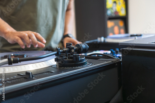 Hands of a sound engineer touching the mixing console in the studio