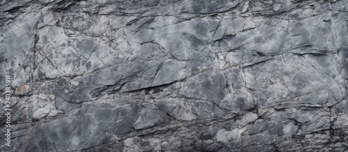 An elevated view of a black and white rugged granite rock wall  showcasing the natural texture and patterns of the stones.