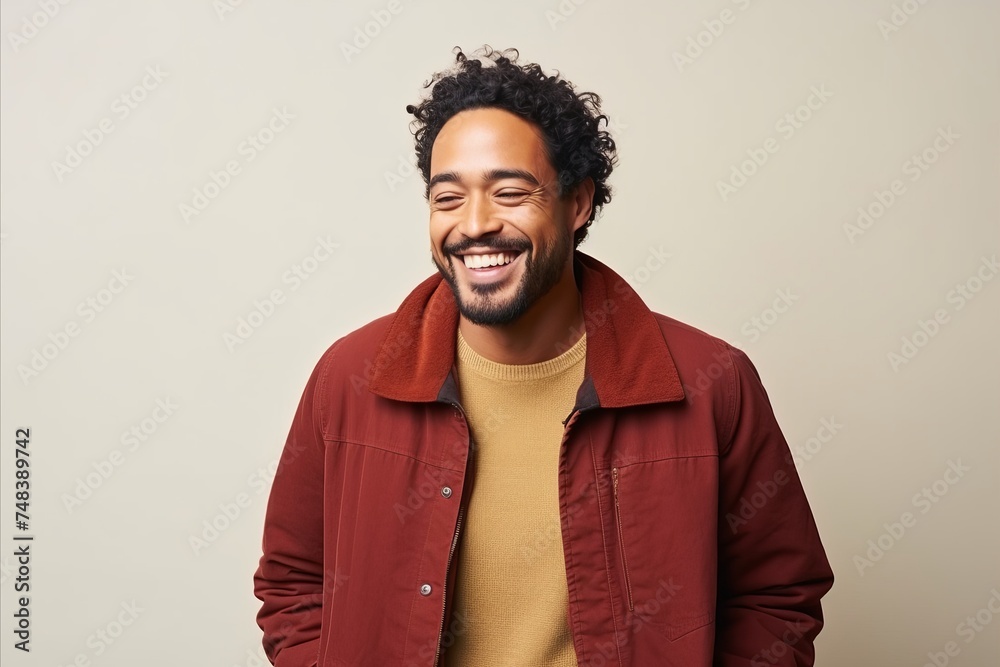 Portrait of a happy african american man laughing against gray background Portrait of a happy african american man laughing against gray background