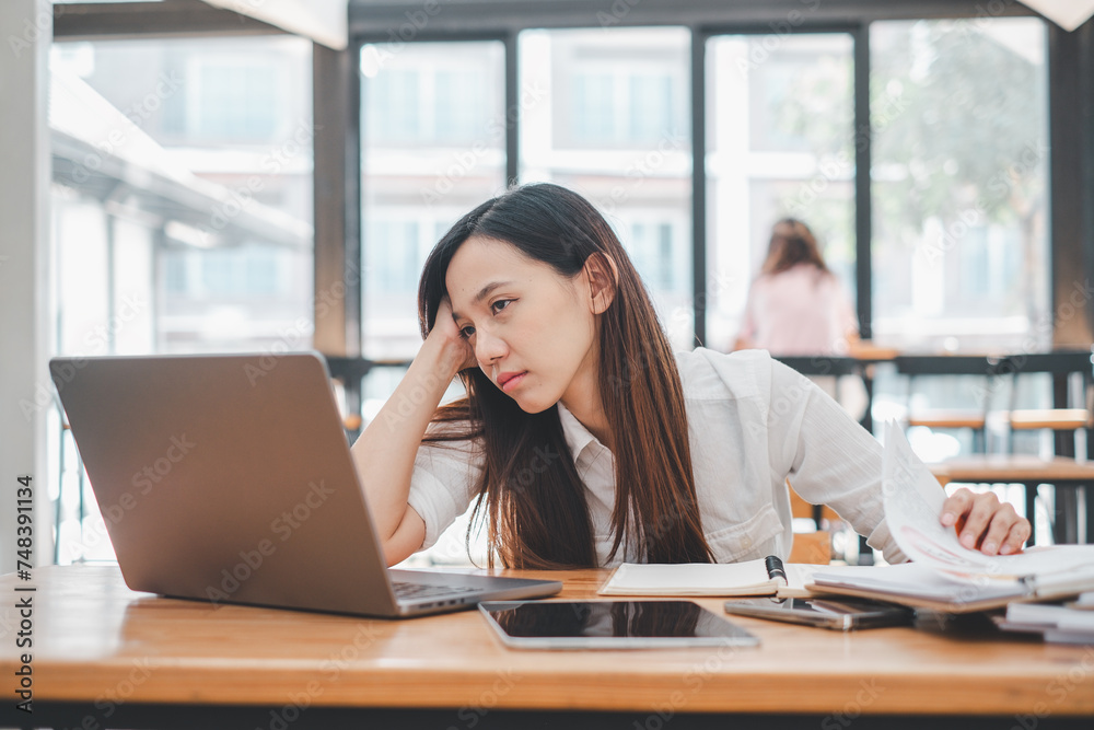 Business problem solving concept, A stressed young woman appears anxious as she concentrates on her laptop, possibly dealing with a tight deadline or challenging work in a bright office space. Business problem solving concept, A stressed young woman appears anxious as she concentrates on her laptop, possibly dealing with a tight deadline or challenging work in a bright office space.