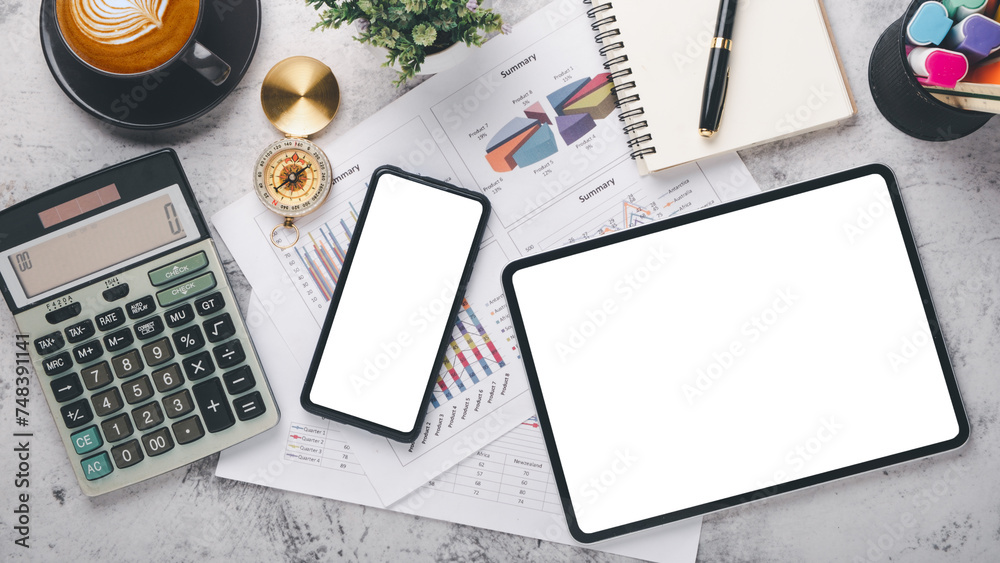 Fototapeta premium A contemporary work desk setup featuring a smartphone, tablet, financial calculator, and coffee, symbolizing organized business planning.
