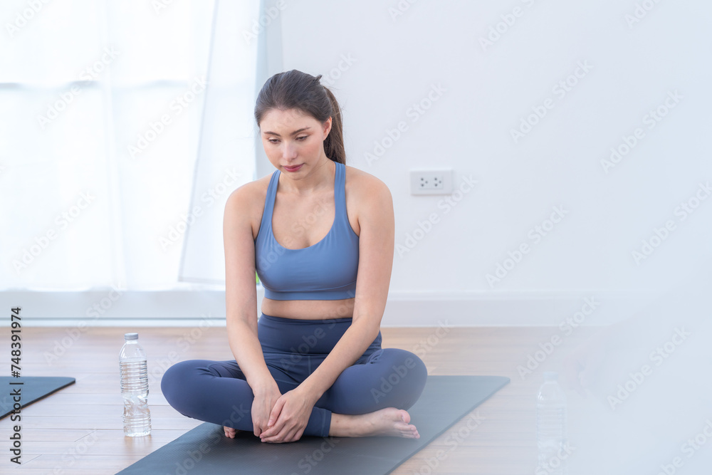 Two women confident training yoga. Athletic women in sportswear doing fitness stretching exercises at home in the living room. Sport and recreation concept. Yoga teacher is helping young woman. Two women confident training yoga. Athletic women in sportswear doing fitness stretching exercises at home in the living room. Sport and recreation concept. Yoga teacher is helping young woman.