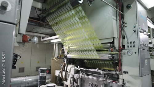 The Inside Scoop on Label Roll Production Process. Labels passing through rollers.