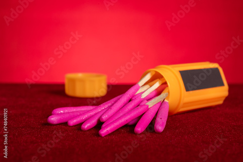 box of windproof and waterproof match sticks on red background at horizontal composition