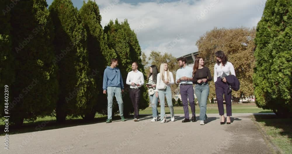 Students enjoy a sunny park day, chatting about school, and relishing the beautiful weather as they stroll together. Students enjoy a sunny park day, chatting about school, and relishing the beautiful weather as they stroll together.