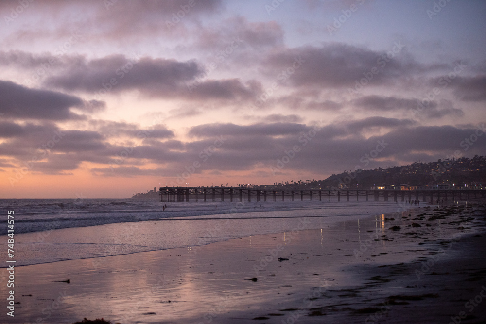 Pier at the Pacific Ocean at Sunset with pink and purple sky