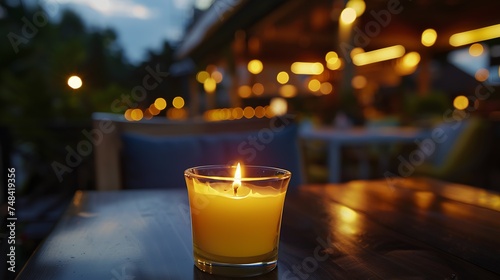 citronella candle with flame outdoor on cafe table setting at dusk for protection against mosquitoes during summer nights : Generative AI photo
