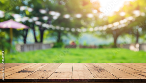 Empty wooden table with party in garden background blurred. and beautiful natural scenery view photo