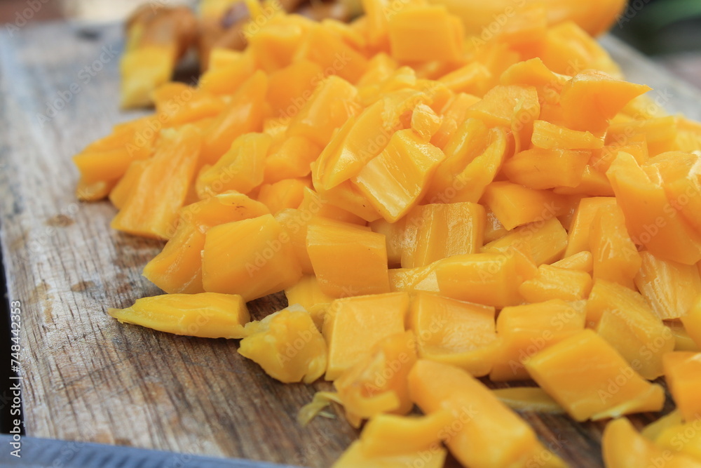 Jackfruit slices on a wooden chopping board on the table Jackfruit slices on a wooden chopping board on the table