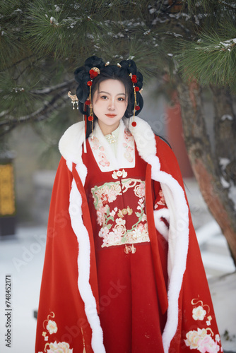 An Asian girl outdoors wearing ancient clothing during the Chinese Spring Festival