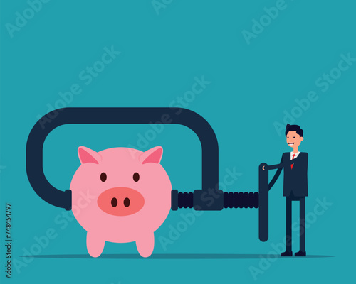 Business person using clamp to squeeze saving pink piggy bank