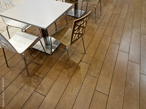 Several chairs and a table on the parquet floor