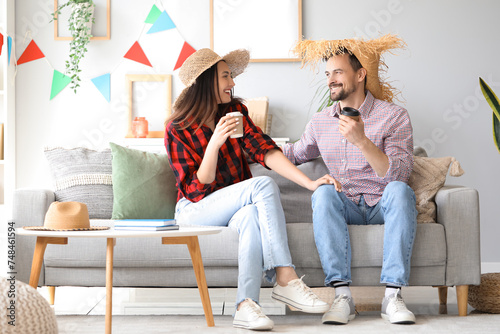 Young couple with cups of c...