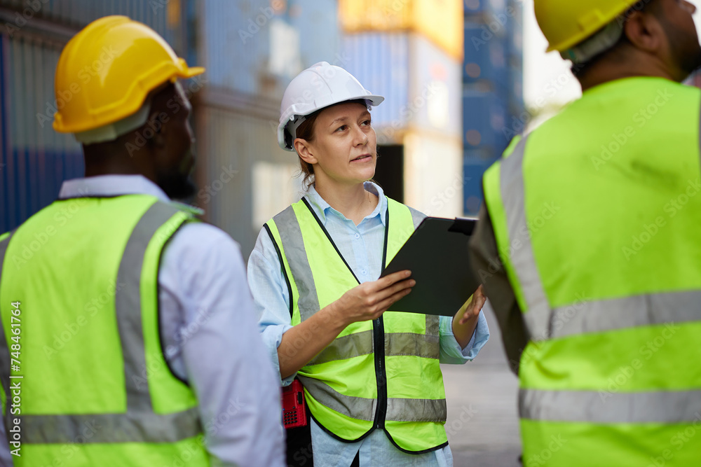 workers and coworkers looking at containers warehouse storage workers and coworkers looking at containers warehouse storage