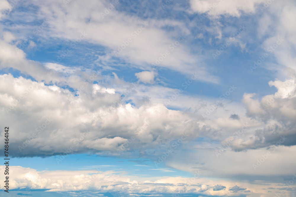 Dramatic white stormy clouds over a blue sky background Dramatic white stormy clouds over a blue sky background